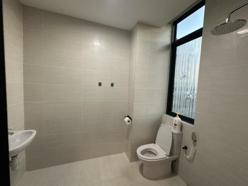 a bathroom with a toilet and a sink at Tropics City Supreme Black Theme Large Balcony City View至尊黑主题大阳台城市风景民宿 in Kuching