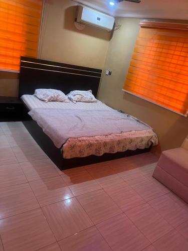 a bedroom with a bed with two pillows on it at Ukayspot in Ifako