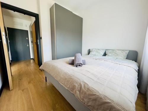 a bedroom with a large bed with a towel on it at Apartament Wiktoria Iława in Iława