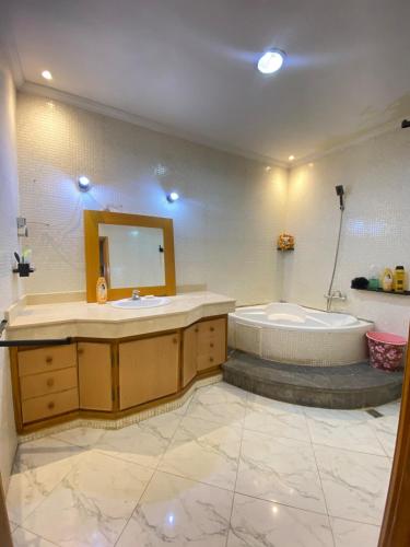 a bathroom with a tub and a sink at Modern apartment in Oujda