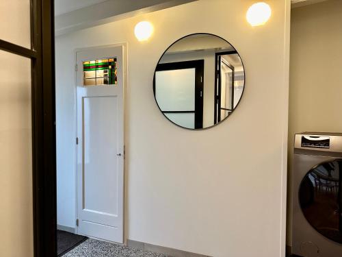 a hallway with a mirror next to a door at Havenhuis TEXEL, per week or weeks Saturday-Saturday in Oudeschild