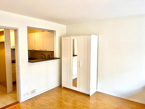an open door to a kitchen in an empty apartment at Downtown Flats, Lake Lucerne in Luzern