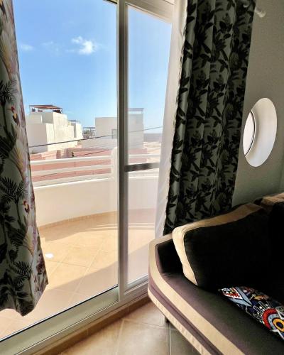 a room with a window with a view of a balcony at African Sunset in Sal Rei