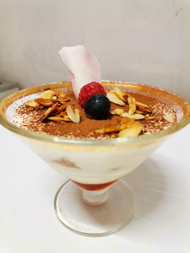 a dessert in a glass bowl on a table at Hotel Restaurant Rose des Pyrénées in Belvianes-et-Cavirac