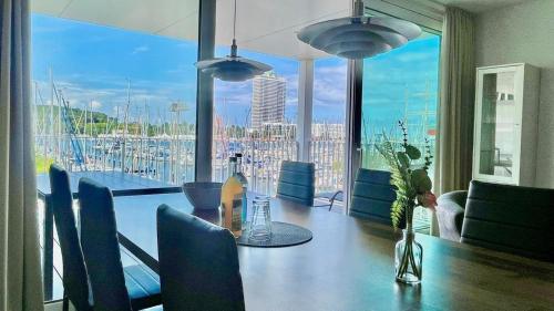 a dining room with a table and a view of a harbor at App 22 3-Zi Whg "Hafenblick" am Passathafen PVA022 in Travemünde