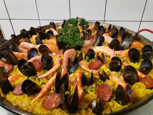 a large plate of food with seafood and vegetables at Hotel Restaurant Rose des Pyrénées in Belvianes-et-Cavirac