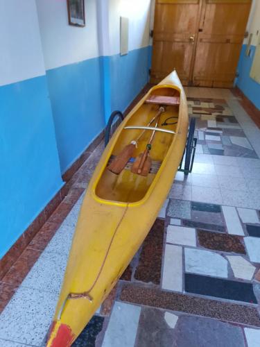 a yellow kayak sitting on a floor in a room at Hotel U Beránků in Libochovice