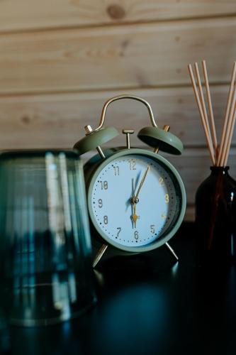 an alarm clock sitting on top of a table at Chata Pod Lasem in Poręba
