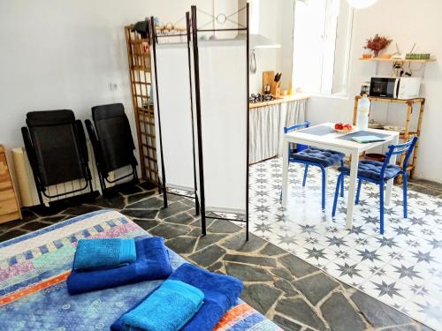 a room with a bed and a table and chairs at O Lagar in Santa Marta de Ortigueira