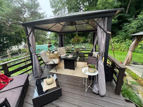 a gazebo with a table and chairs on a deck at S and S Homestead in Rochester