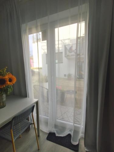 a room with a sliding glass door to a patio at Ludna 27 in Niechorze