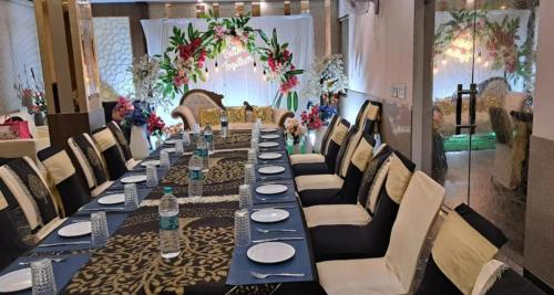 a long table with plates and water bottles on it at Hotel president jodhpur in Jodhpur