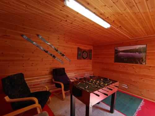 a room with a table and chairs in a log cabin at Paljarinne in Hulmi