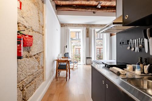 a kitchen with a counter top and a table at Belomonte 22 Apartments Porto World Heritage in Porto