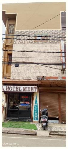 a motorcycle parked in front of a hotel motel at LUCKNOW HOTEL MEET - Near Railway Station #Fully Air-Condition #Free Wi-Fi #Parking Facilities - BEST BUDGET HOTEL IN LUCKNOW in Lucknow
