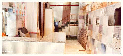 a hallway of a building with a tile wall at LUCKNOW HOTEL MEET - Near Railway Station #Fully Air-Condition #Free Wi-Fi #Parking Facilities - BEST BUDGET HOTEL IN LUCKNOW in Lucknow