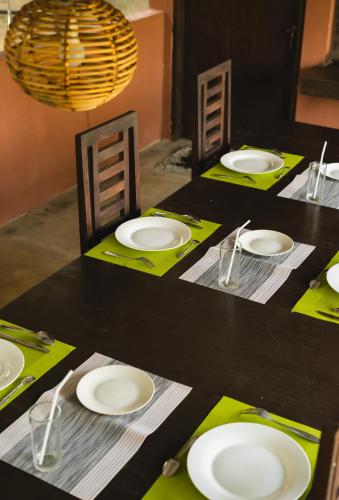 a black table with white plates on top of it at Yala Green Eco Lodge in Kirinda