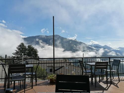 a table and chairs on a balcony with a view of a mountain at Orèn b&b in Casargo