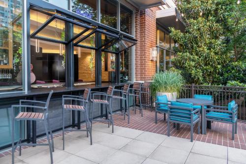 a group of chairs and tables in front of a restaurant at Hilton Garden Inn Nashville Downtown Convention Center in Nashville