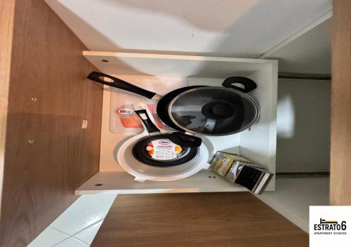 a coffee maker is in a cabinet in a kitchen at Estrato6 Apart Studios in Villanueva