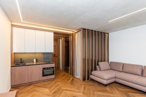 a living room with a couch and a kitchen at Sea Waves Apartment in Palanga