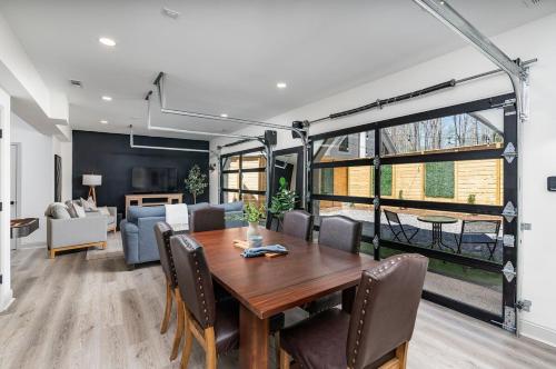 a dining room with a table and a living room at Pickleball - 2 Master Suites - Fire Pit - Game Rm in Nellysford