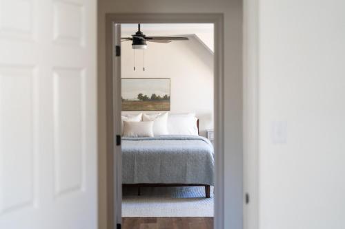 a bedroom with a bed with a ceiling fan at Pickleball - 2 Master Suites - Fire Pit - Game Rm in Nellysford