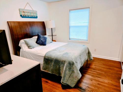 a bedroom with a bed with a wooden headboard at 2 Bedroom Kitchen and Living Area in Fayetteville