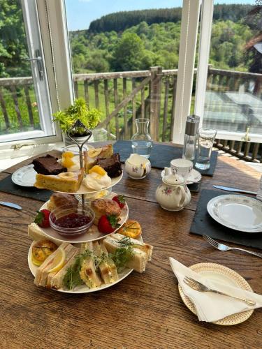 a table with three plates of food on it at Lydgate House Hotel in Postbridge