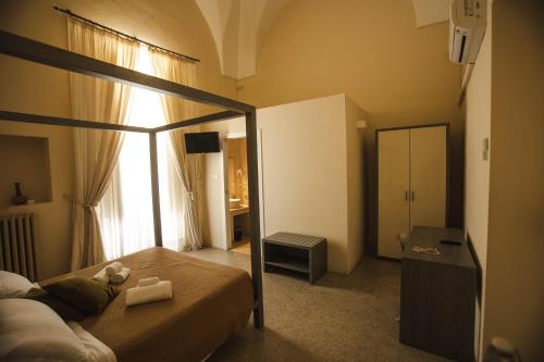 a bedroom with a bed and a large window at 4 Balconi rooms-Boutique B&B in Lecce