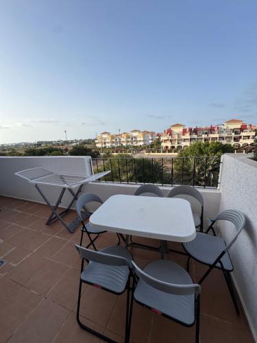 ein Tisch und Stühle auf einem Balkon mit Aussicht in der Unterkunft 3 Bedroom Apartment with pool for family in Saidia 