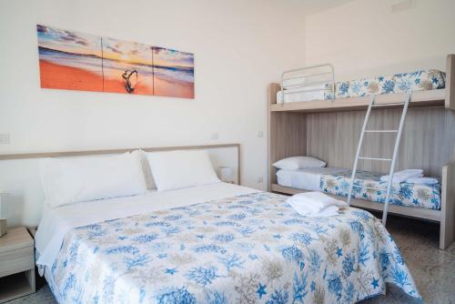 a bedroom with two bunk beds and a ladder at Hotel Indaco in Marina di Casalvelino
