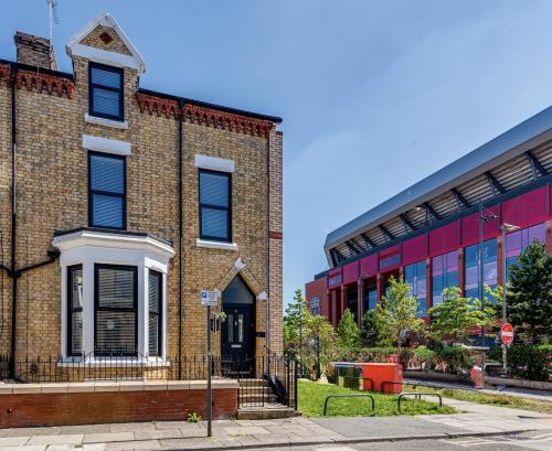 a brick building with a red building at The Rockfield by Serene Stays Stylish 6BR near Anfield with Bar Virgin Media and Fast WiFi in Liverpool