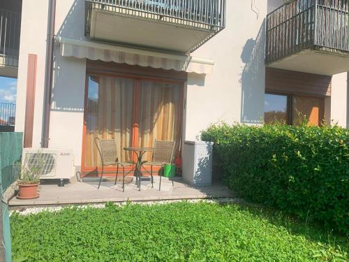 a patio with a table and chairs in a house at Casa Vacanze La Madoneta in Colico
