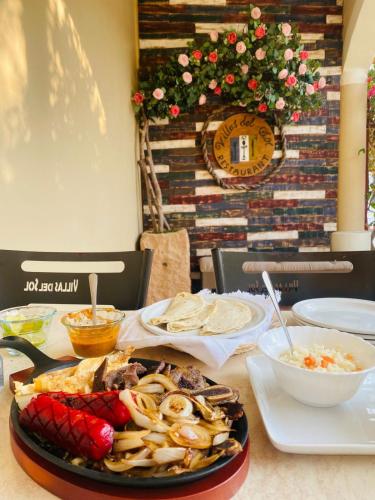 a table with a plate of food on a table at Hotel y Restaurante Villas Del Sol Jalpan de Serra in Jalpan