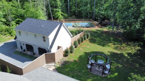 an aerial view of a house and a yard at Pickleball - 2 Master Suites - Fire Pit - Game Rm in Nellysford
