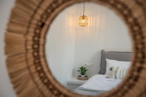 a mirror reflection of a bed in a bedroom at Anthea Suites in Engares