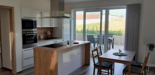 a kitchen with a sink and a table with a dining room at Apartmán u Štěpána 