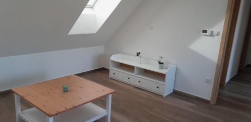 a white room with a table and a sink at Apartmán u Štěpána 