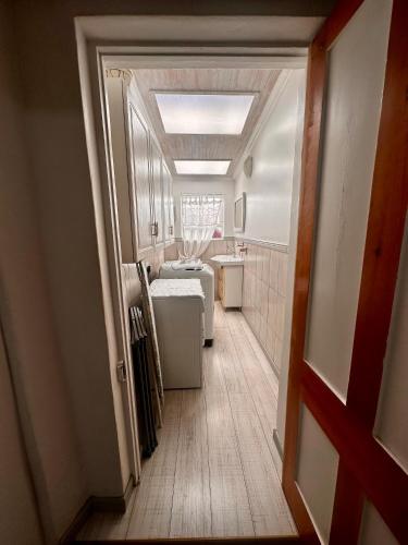 a hallway leading to a bathroom with a sink at Corner Cottage on Hill in Mossel Bay