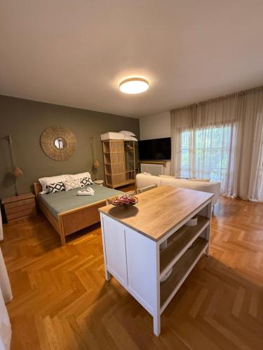 a living room with a bed and a couch at Quiet luxury studio next to airport in Paianía