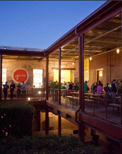 a group of people sitting outside of a building at 1280 Bungalow in Atlanta