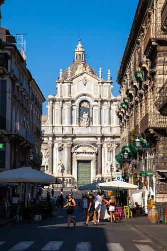 a large white building with people walking in front of it at Dimora Di Nardo in Catania