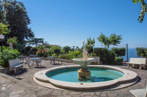 a fountain with a statue in the middle of a patio at Grand Hotel Moon Valley in Vico Equense