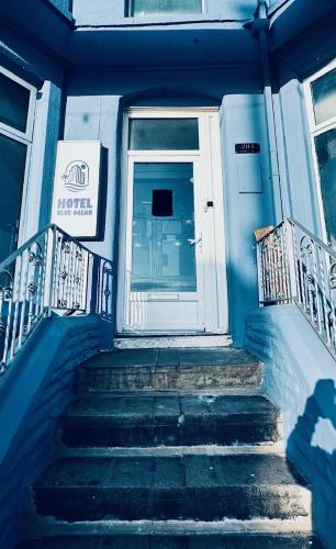 a blue building with stairs leading to a door at HOTEL BLUE OCEAN - Call For Cheap Prices - Check In Until 3AM in Blackpool