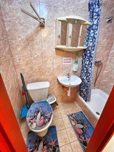 a bathroom with a toilet and a sink and a tub at Penzion Estetika in Jaroslavice