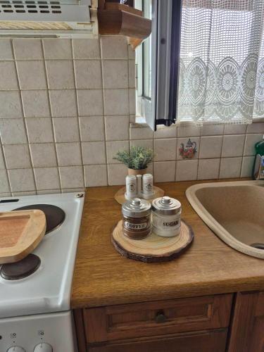 a kitchen with a counter with a stove and a sink at Niko’s House in Kerames