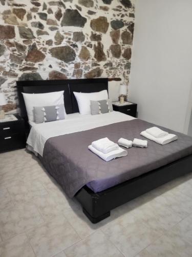 a bedroom with a large bed with towels on it at Niko’s House in Kerames