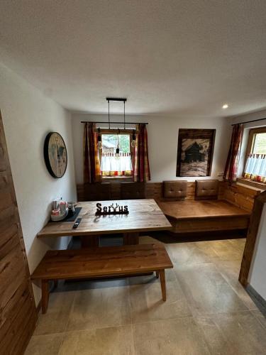 a living room with a table and a couch at Haus Bergliebe in Winkl Reichenau
