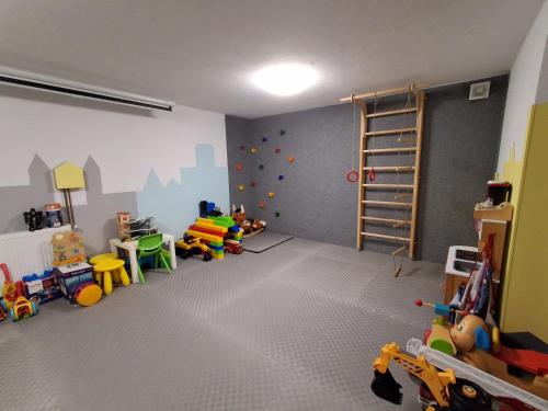 a room with a play room with toys and a ladder at Ludna 27 in Niechorze